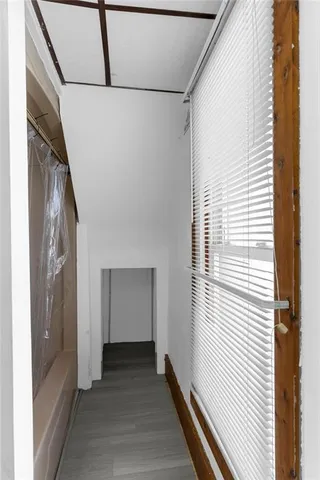a view of a hallway with wooden floor and staircase