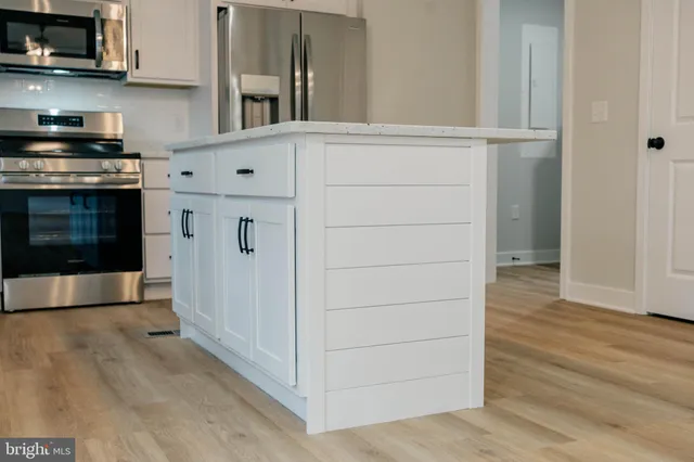 a kitchen with cabinets and a stove