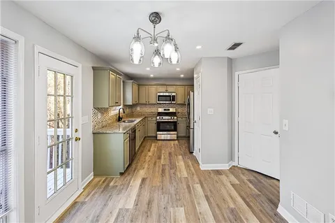 a kitchen that has a sink and a stove top oven