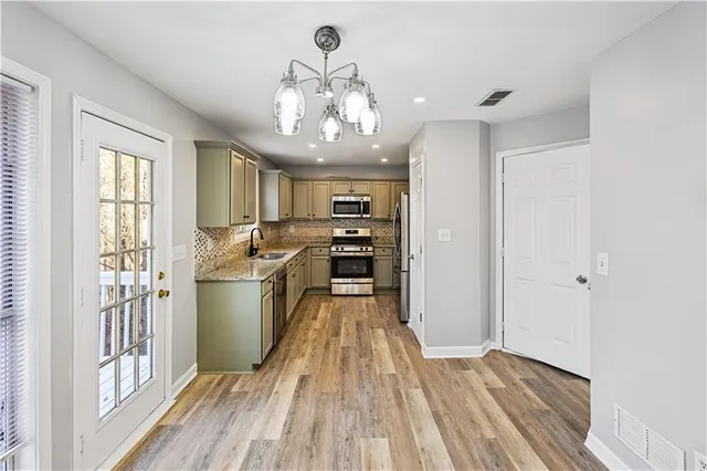 a kitchen that has a sink and a stove top oven