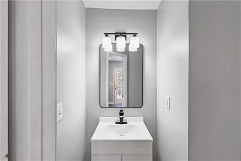 a bathroom with a sink vanity and mirror
