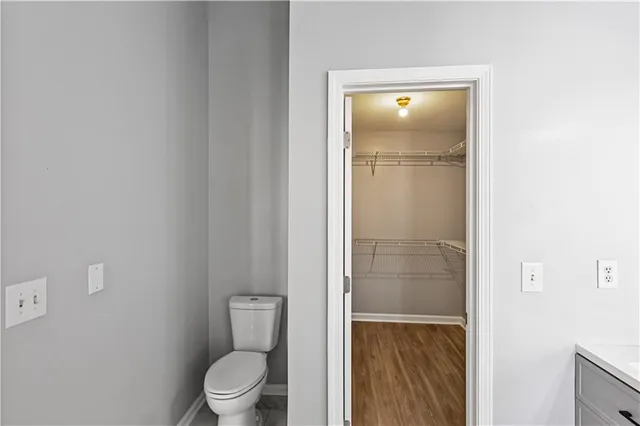 a view of walk in closet with empty racks