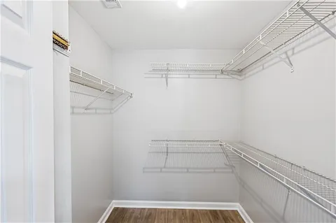 a view of a room with wooden floor