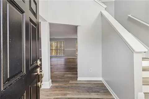 a view of hallway with wooden floor