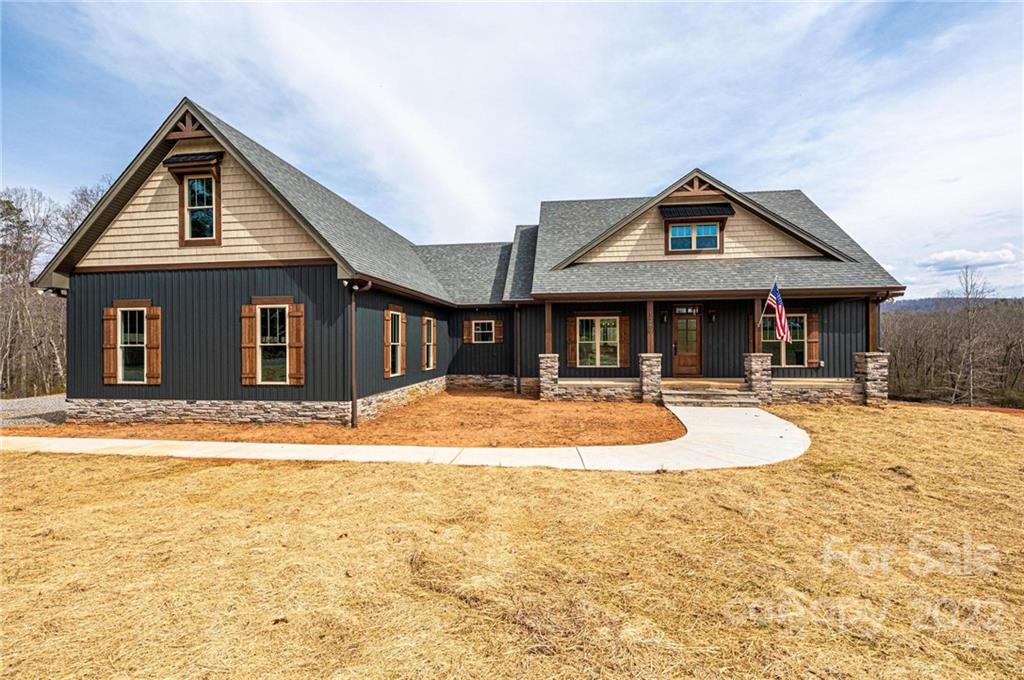 1289 Hopewell Church Road Hiddenite, NC 28636 - Photo 1 of 48 a front view of a house with a yard and garage
