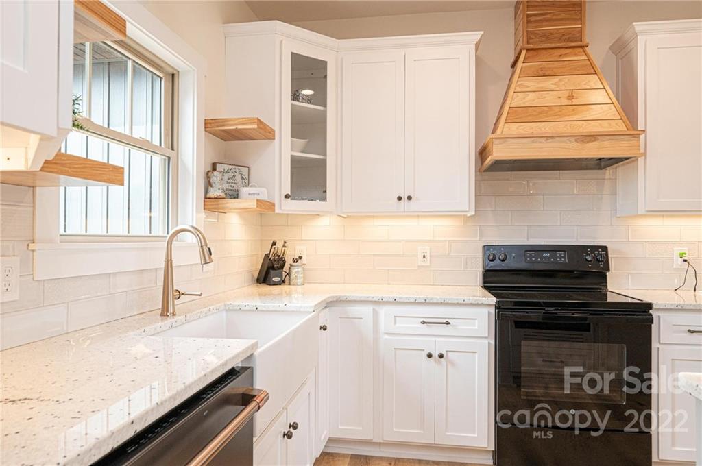 1289 Hopewell Church Road Hiddenite, NC 28636 - Photo 24 of 48 a kitchen with a sink stove and cabinets