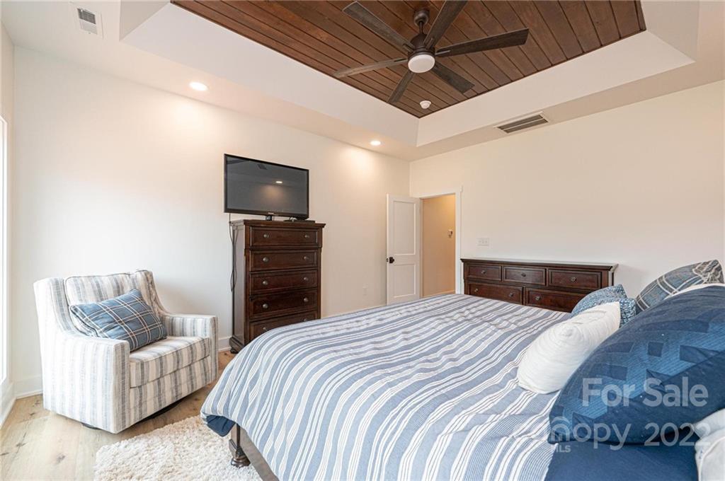 1289 Hopewell Church Road Hiddenite, NC 28636 - Photo 27 of 48 a bedroom with a bed and a couch