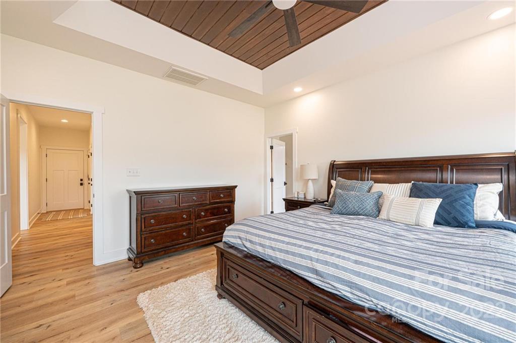 1289 Hopewell Church Road Hiddenite, NC 28636 - Photo 28 of 48 a bedroom with a bed and wooden floor