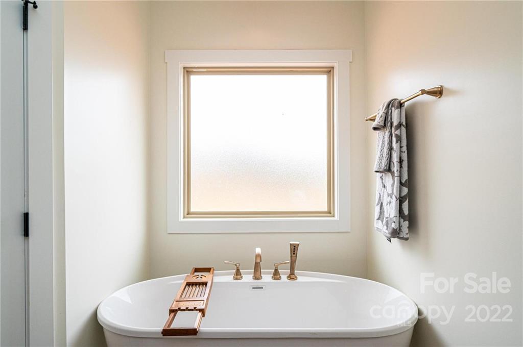 1289 Hopewell Church Road Hiddenite, NC 28636 - Photo 29 of 48 a white bath tub sitting next to a white sink