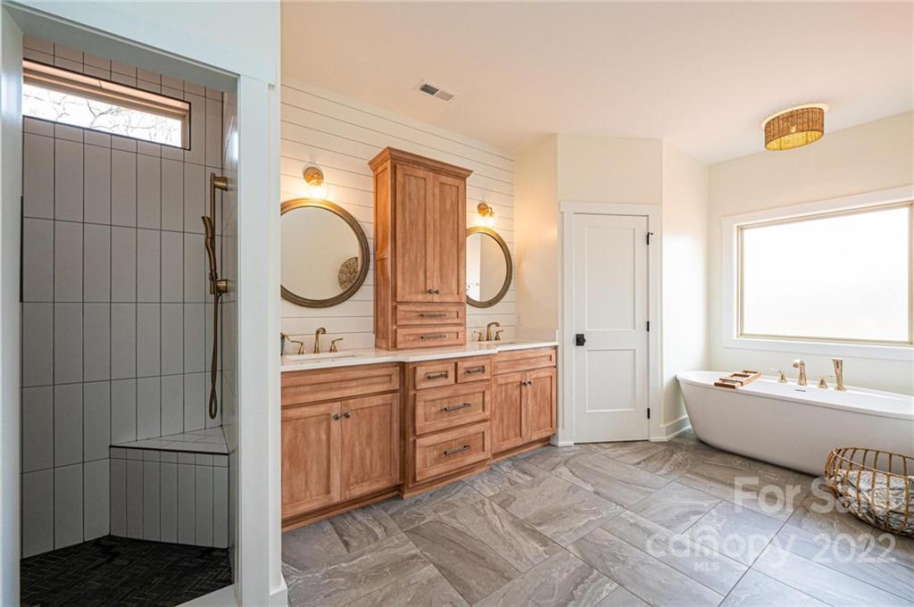 1289 Hopewell Church Road Hiddenite, NC 28636 - Photo 30 of 48 a spacious bathroom with a tub sink and mirror