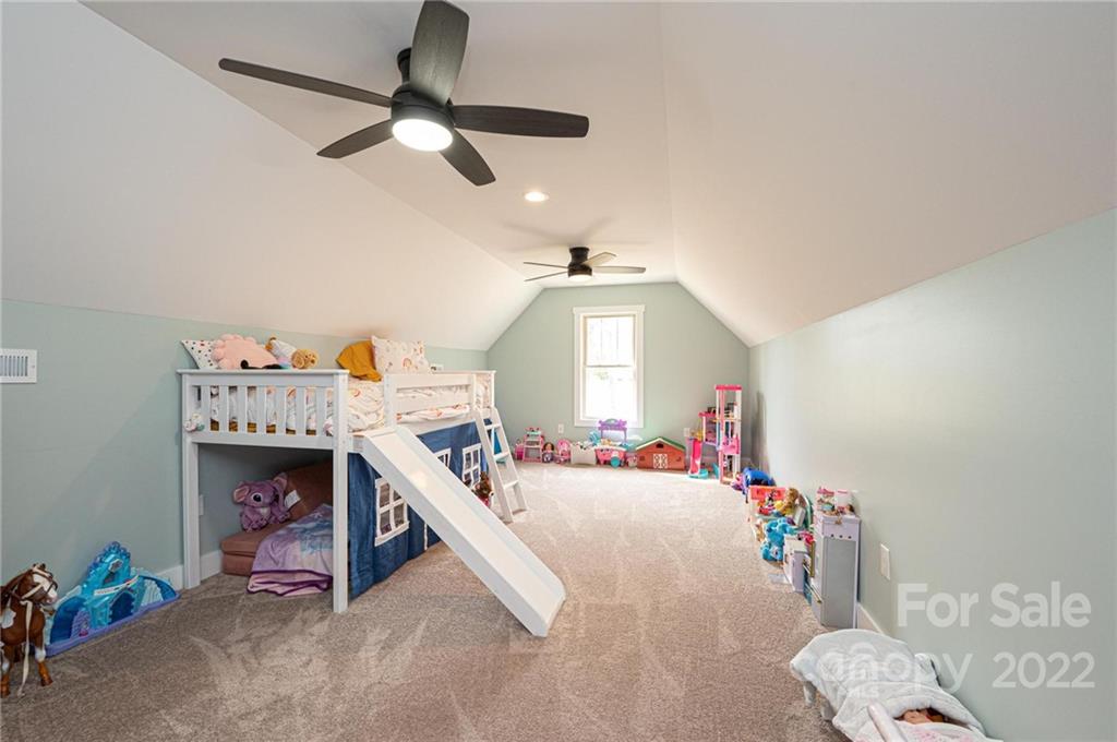 1289 Hopewell Church Road Hiddenite, NC 28636 - Photo 38 of 48 a bed room with a bed and a chandelier