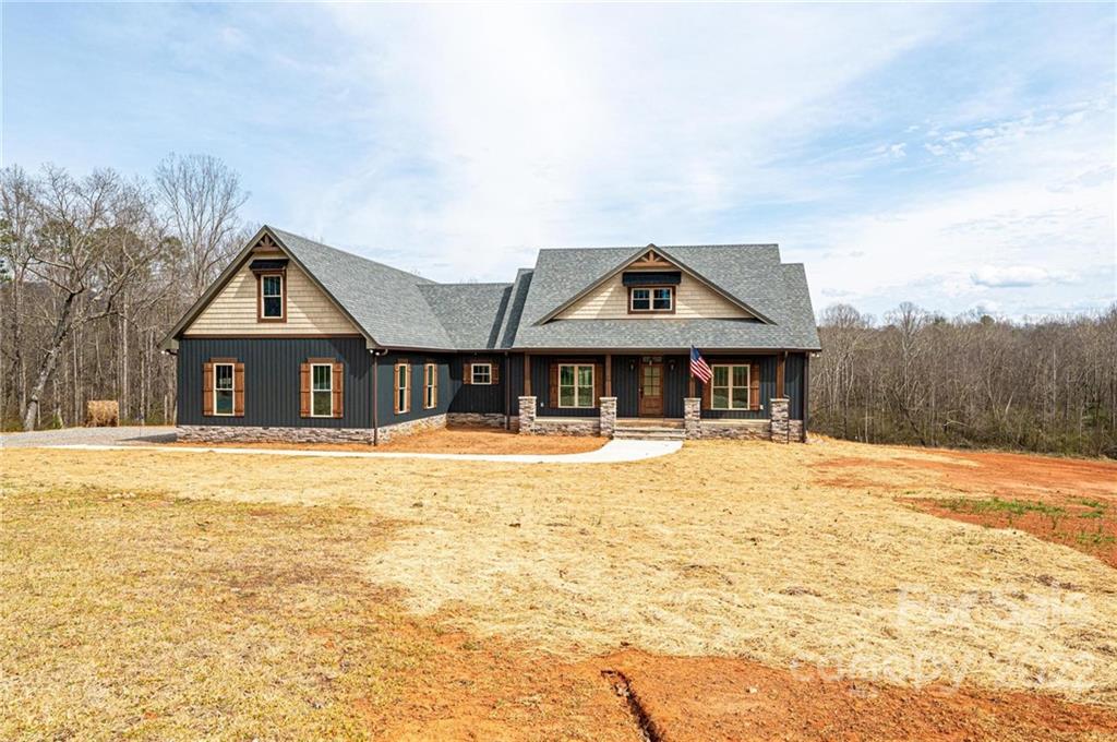 1289 Hopewell Church Road Hiddenite, NC 28636 - Photo 10 of 48 a front view of house with yard and trees in the background