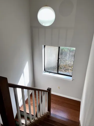 a view of staircase with wooden floor