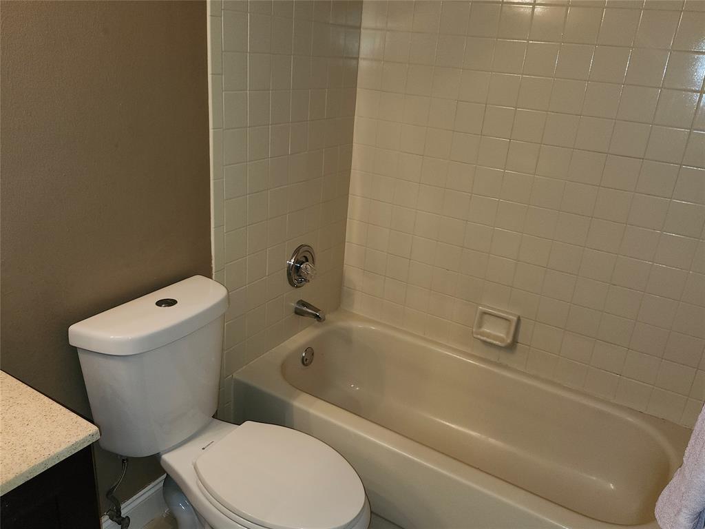4192 Southwest 87th Terrace Davie, FL 33328 - Photo 18 of 35 a white toilet and tub sitting next to a bathroom sink