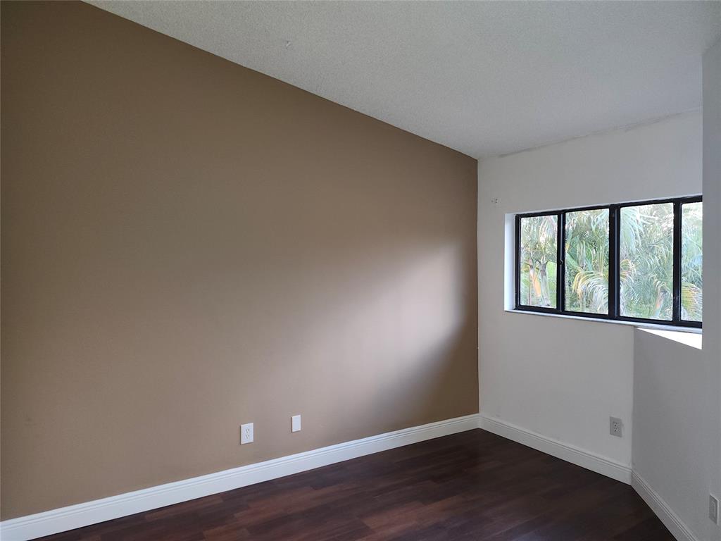 4192 Southwest 87th Terrace Davie, FL 33328 - Photo 26 of 35 a view of an empty room with wooden floor and a window
