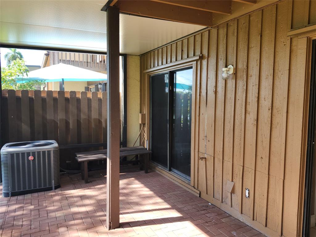 4192 Southwest 87th Terrace Davie, FL 33328 - Photo 27 of 35 a view of a porch with a door and wooden fence