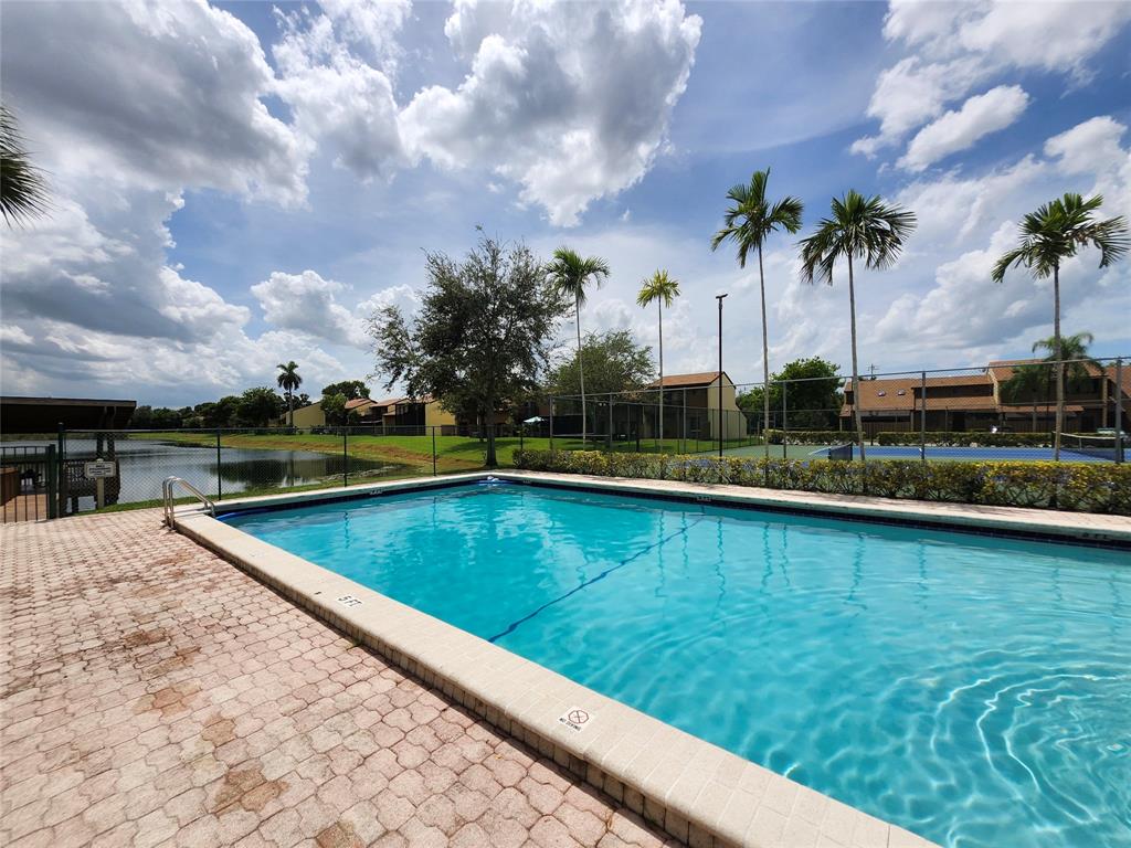 4192 Southwest 87th Terrace Davie, FL 33328 - Photo 30 of 35 a view of swimming pool with outdoor seating and yard in back