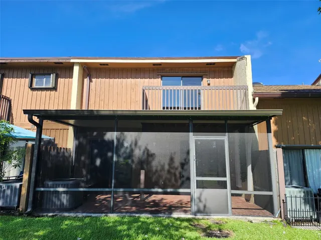 a backyard of a house with table and chairs