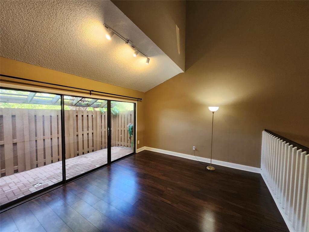 4192 Southwest 87th Terrace Davie, FL 33328 - Photo 5 of 35 an empty room with wooden floor and windows