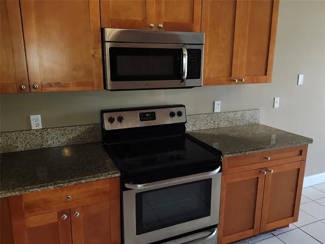 a kitchen with stainless steel appliances a refrigerator sink and cabinets