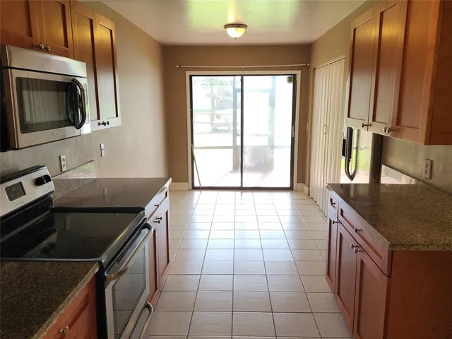 a kitchen with stainless steel appliances granite countertop a stove microwave and oven