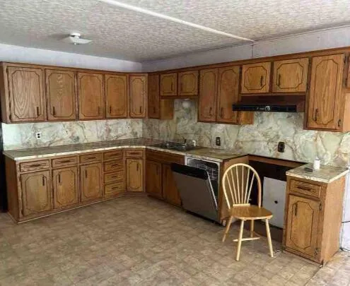 a kitchen with a sink cabinets and window