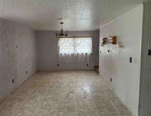 an empty room with windows and entrance