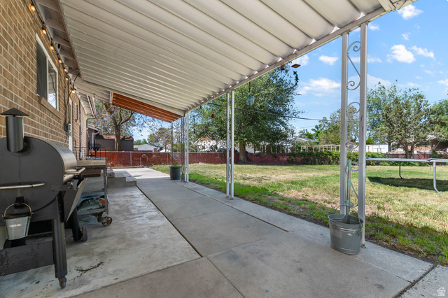 9902 South Poppy Lane Sandy, UT 84094 - Photo 20 of 25 Covered patio area featuring a concrete surface and decorative metal supports