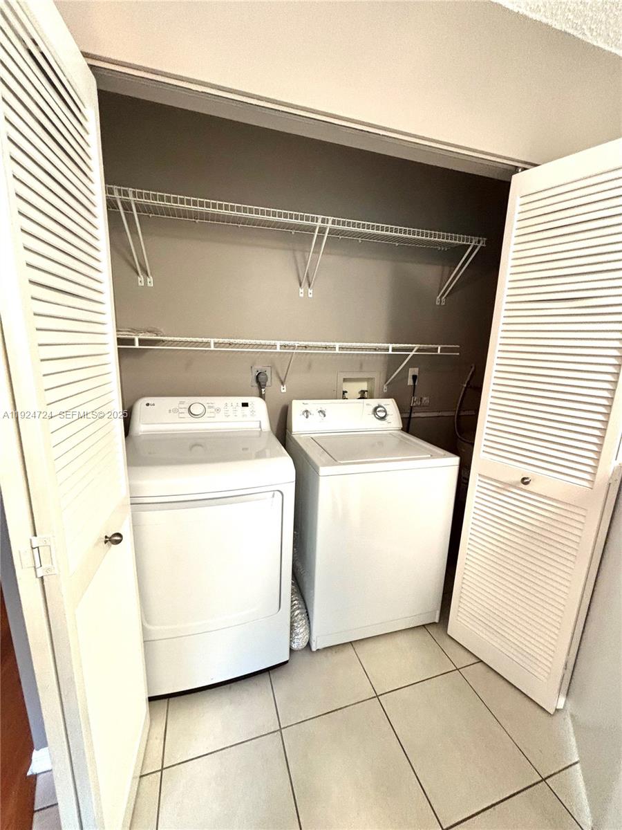 6965 Northwest 173rd Drive, Unit 1904 Hialeah, FL 33015 - Photo 14 of 14 a utility room with dryer and washer
