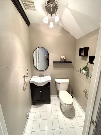a bathroom with a sink a toilet and mirror