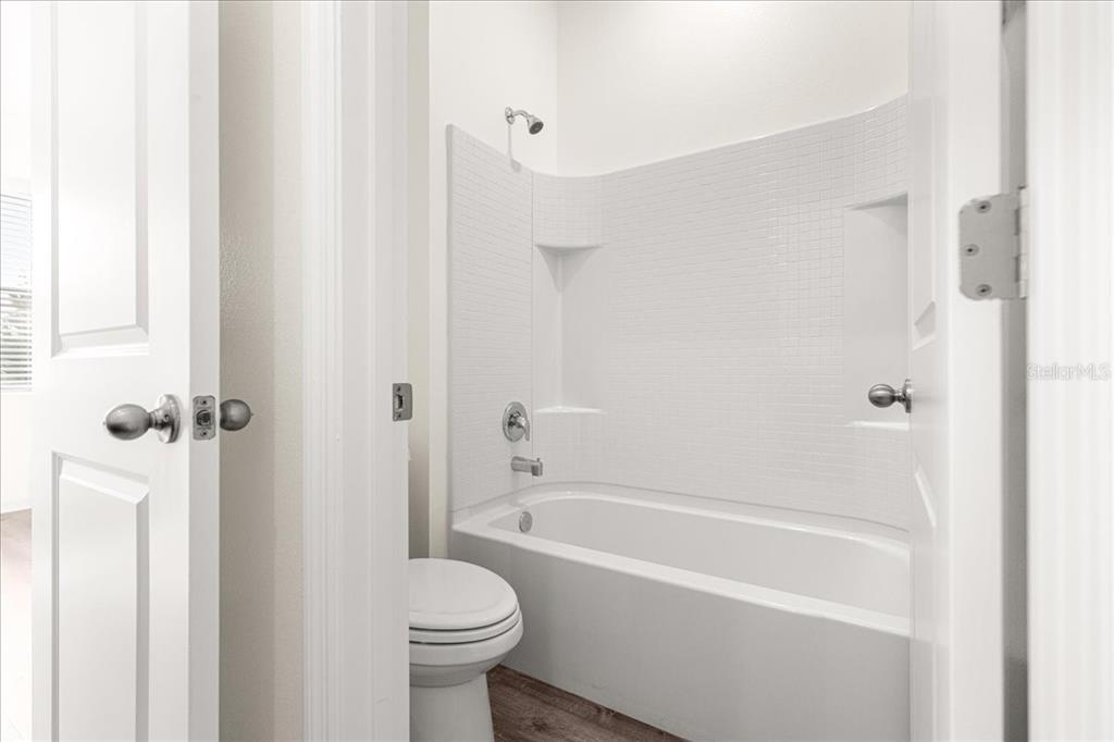 5851 Southwest 85th Place Ocala, FL 34476 - Photo 33 of 57 a bathroom with a bathtub and a shower