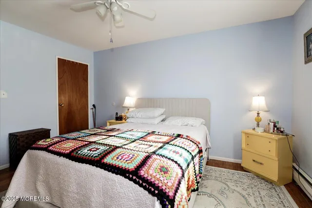 a bedroom with a bed and a tv on the dresser