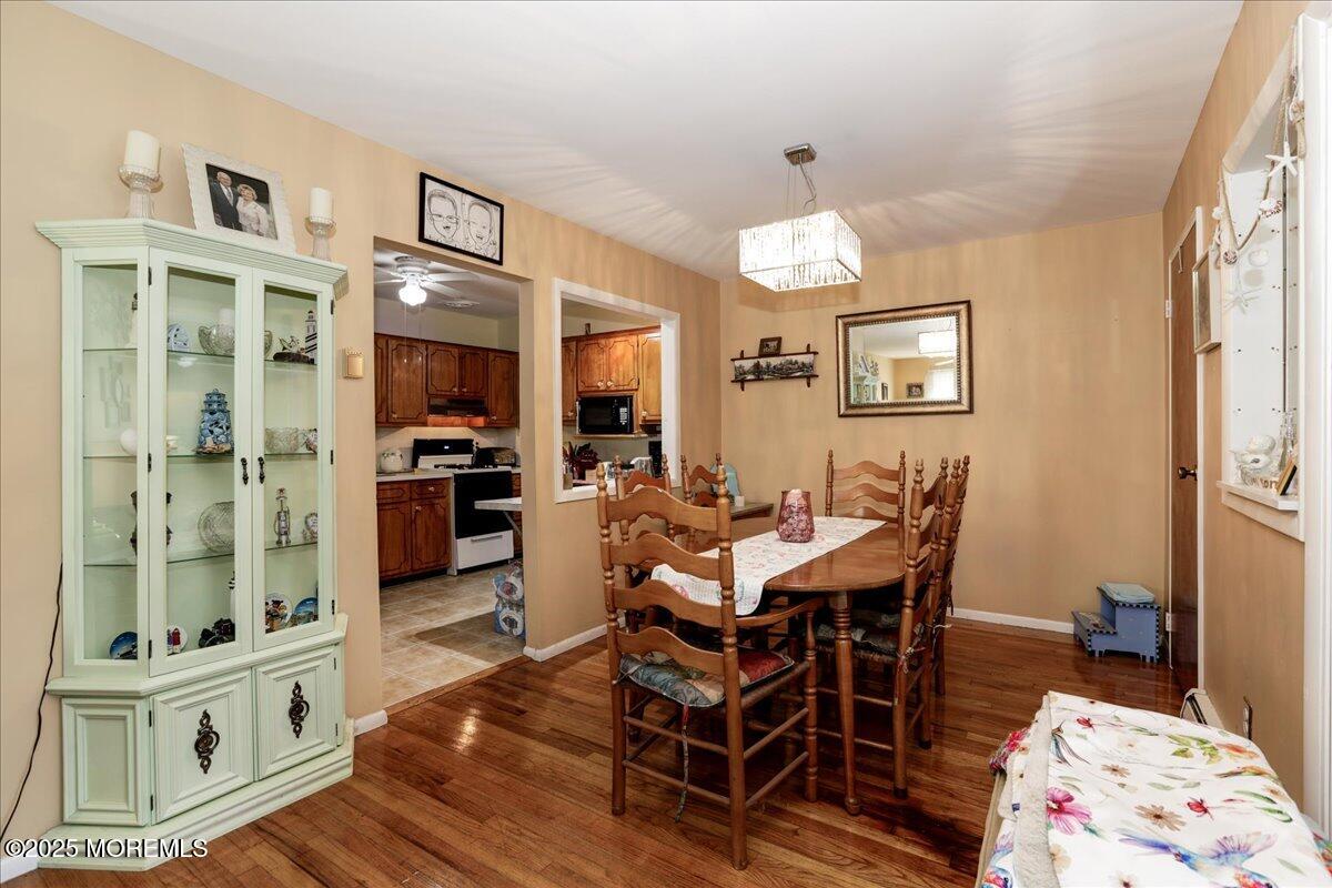 9 D Cardinal Street Manchester Township, NJ 08759 - Photo 7 of 30 a view of a dining room with furniture a chandelier and wooden floor
