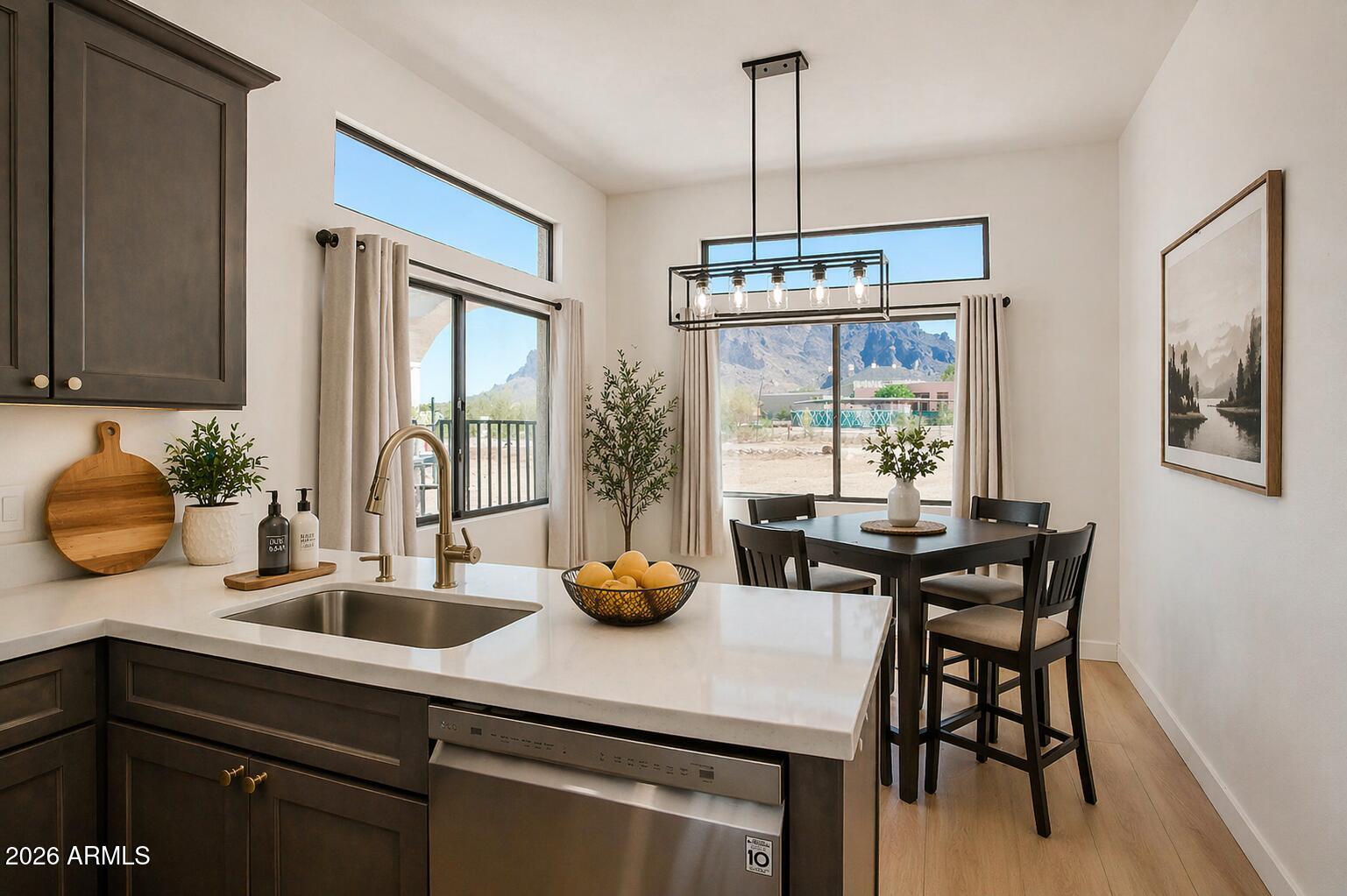 310 North Mountain View Road Apache Junction, AZ 85119 - Photo 4 of 14 a kitchen with a sink a stove and a table