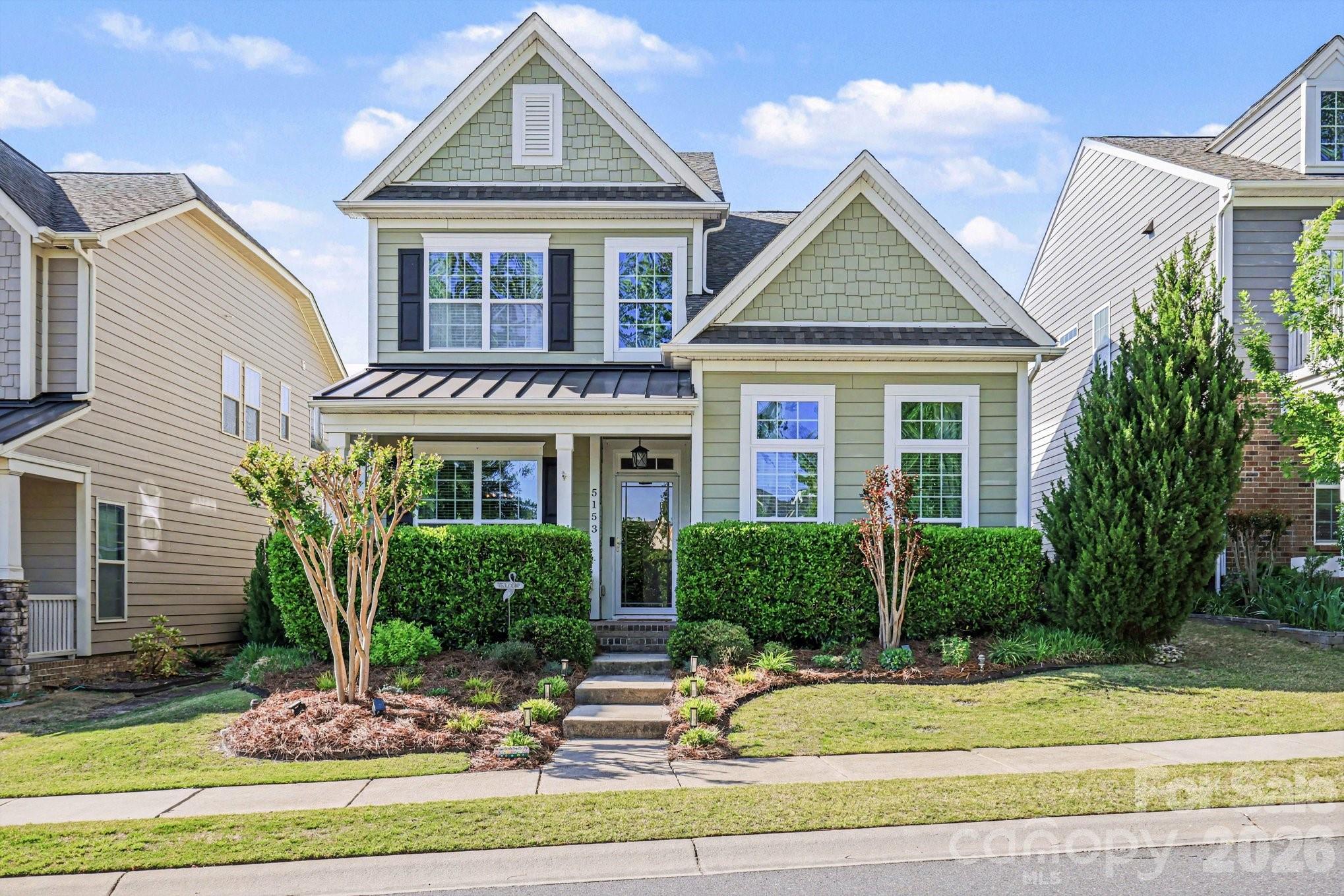 5153 Waterloo Drive Tega Cay, SC 29708 - Photo 1 of 29 a front view of a house with garden
