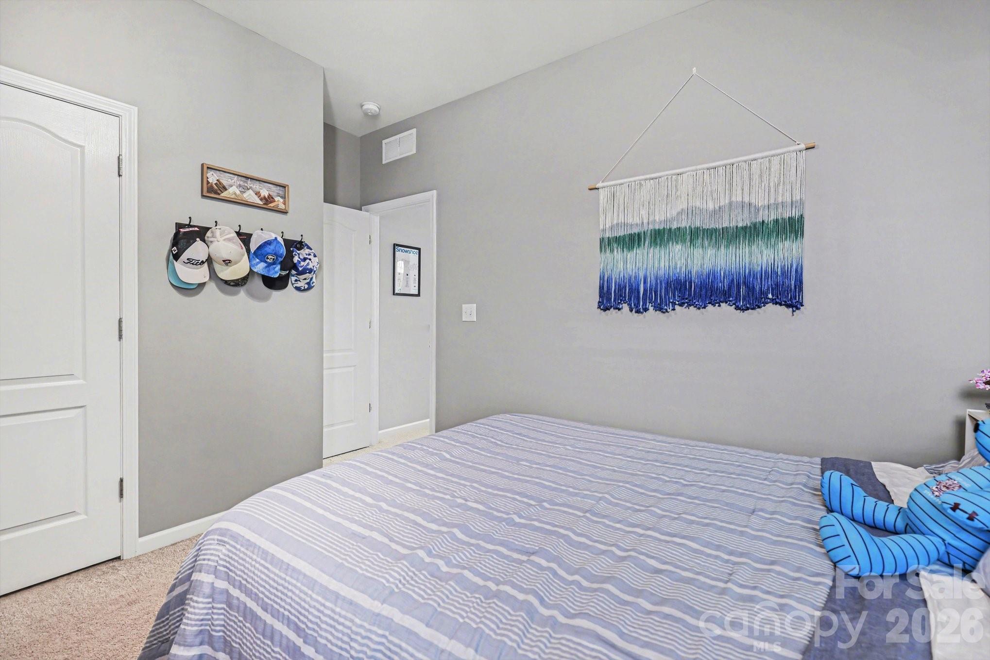 5153 Waterloo Drive Tega Cay, SC 29708 - Photo 19 of 29 a bedroom with a bed and painting on the wall