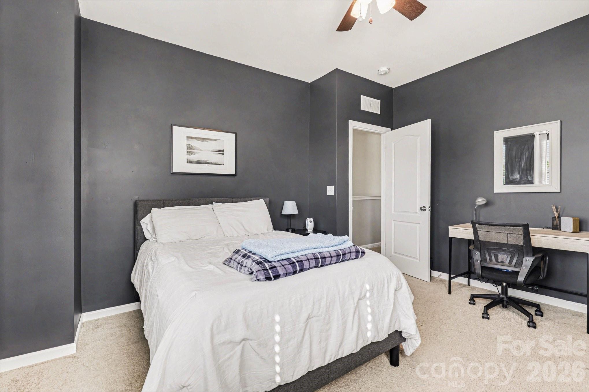 5153 Waterloo Drive Tega Cay, SC 29708 - Photo 20 of 29 a bedroom with a bed a chair and a chandelier