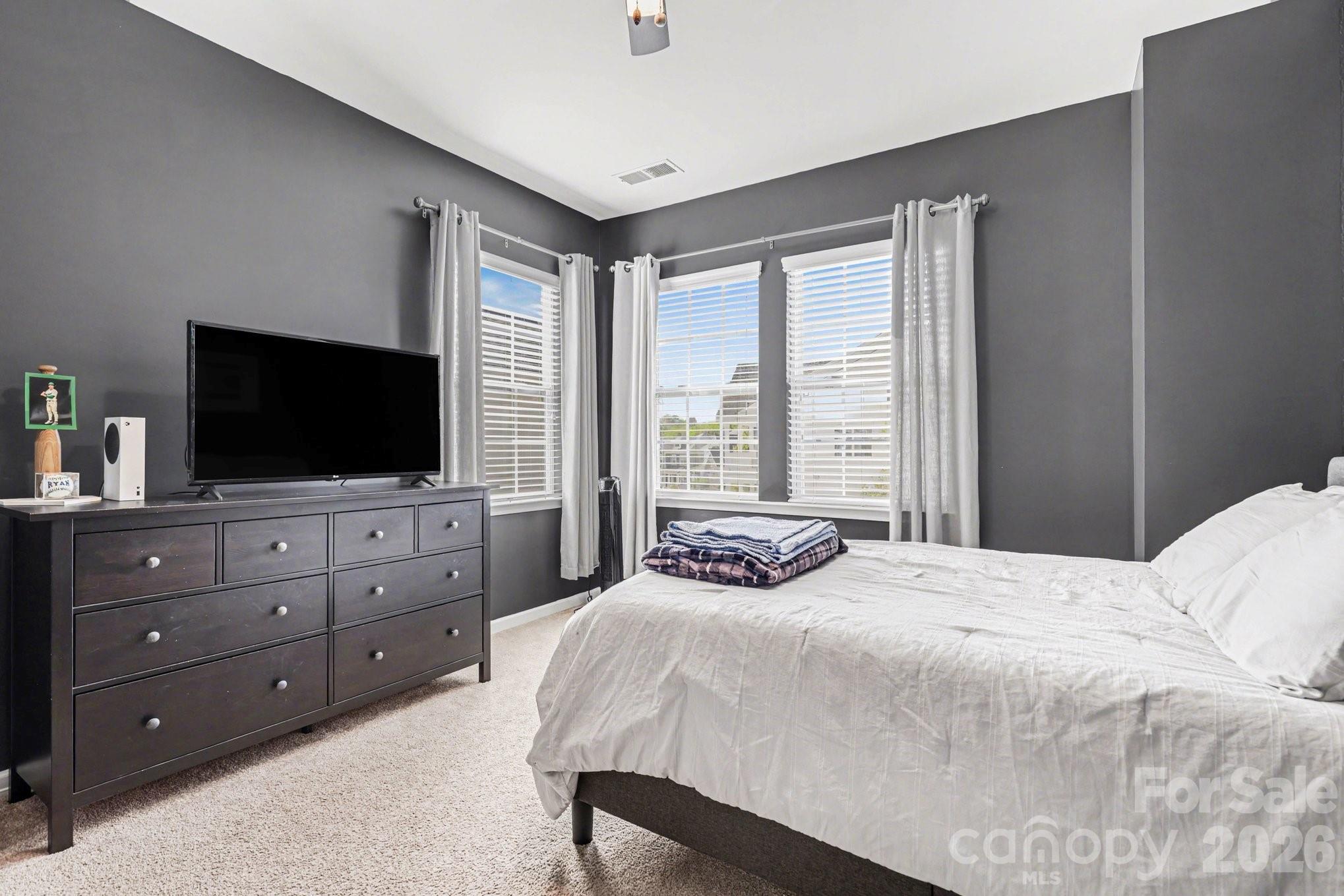 5153 Waterloo Drive Tega Cay, SC 29708 - Photo 21 of 29 a bedroom with a large bed and a flat screen tv