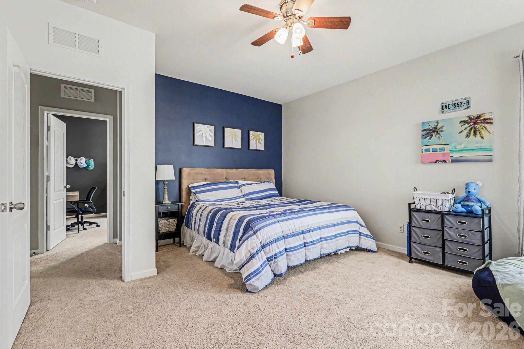 5153 Waterloo Drive Tega Cay, SC 29708 - Photo 23 of 29 a bedroom with a bed and a chandelier