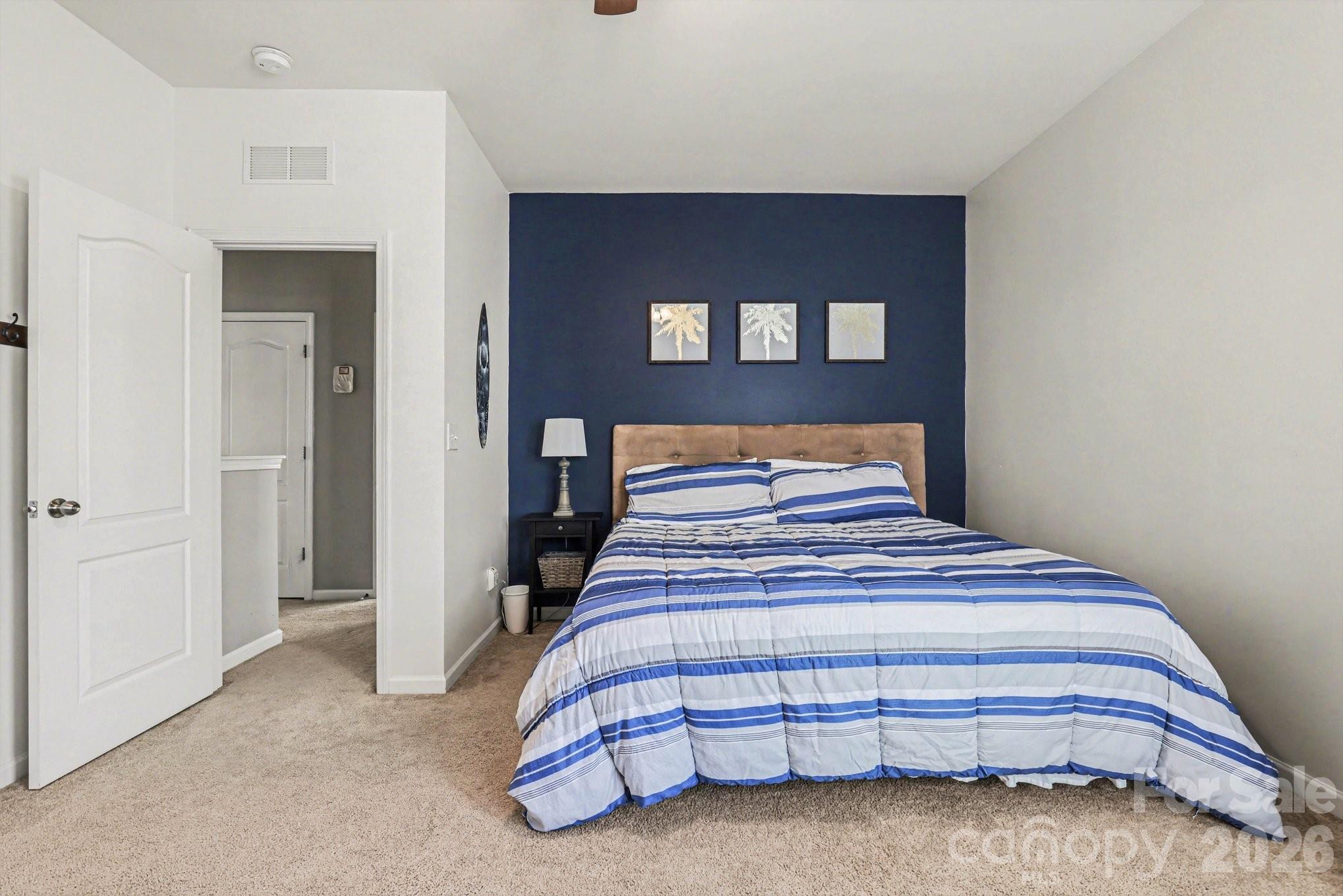 5153 Waterloo Drive Tega Cay, SC 29708 - Photo 24 of 29 a bedroom with a bed and mirror
