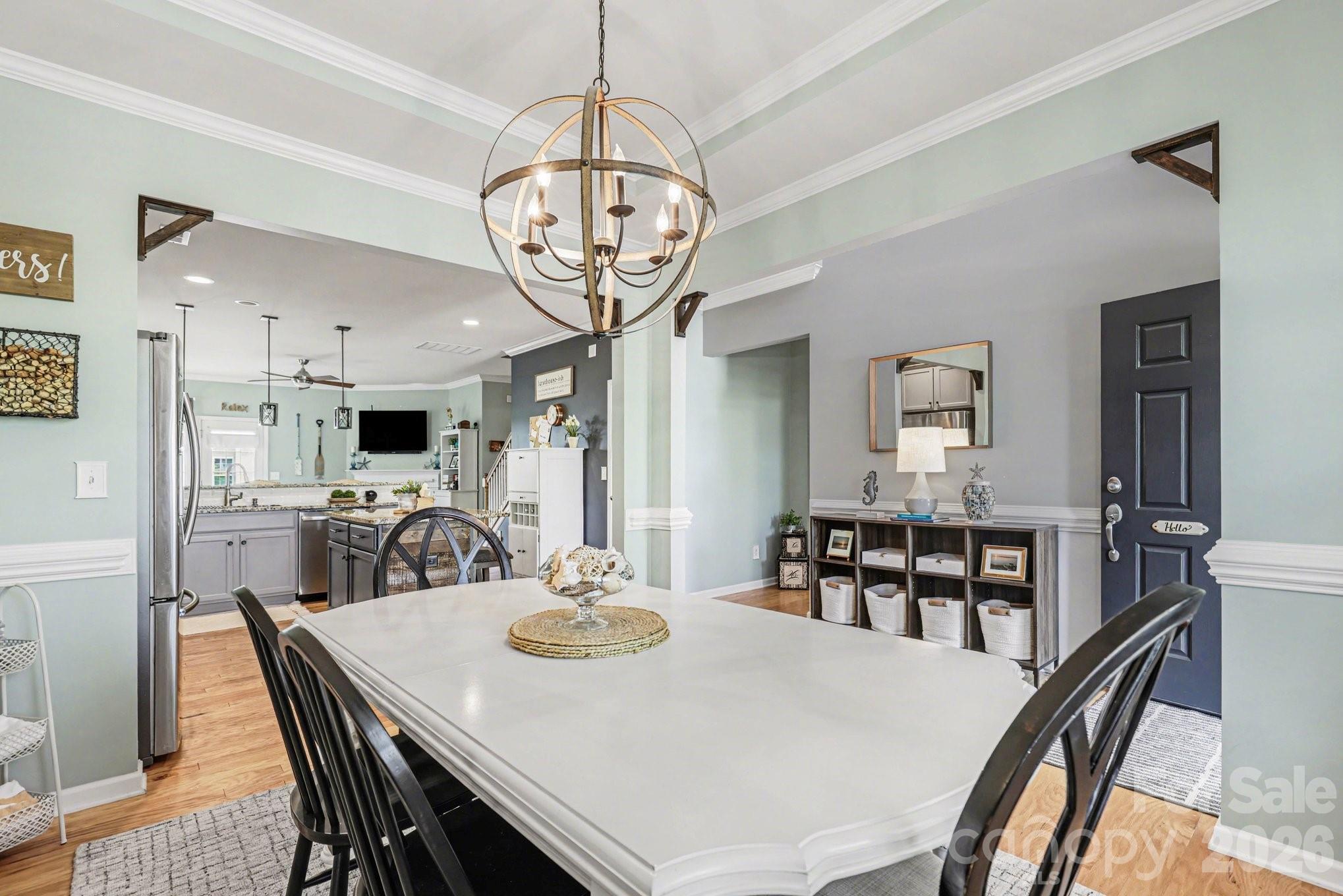 5153 Waterloo Drive Tega Cay, SC 29708 - Photo 6 of 29 a view of a dining room with furniture a chandelier and wooden floor