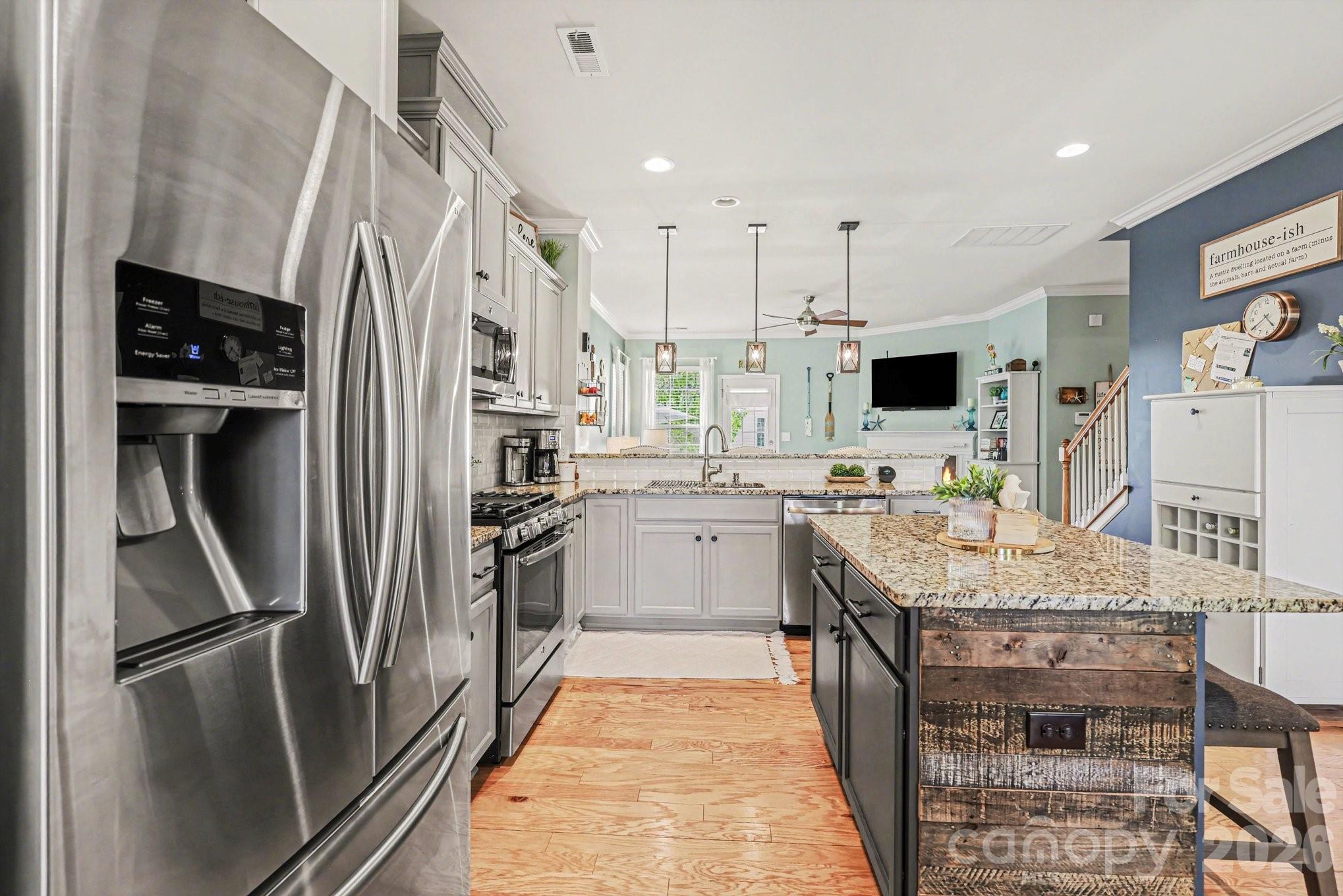 5153 Waterloo Drive Tega Cay, SC 29708 - Photo 7 of 29 a kitchen with stainless steel appliances a refrigerator sink and microwave
