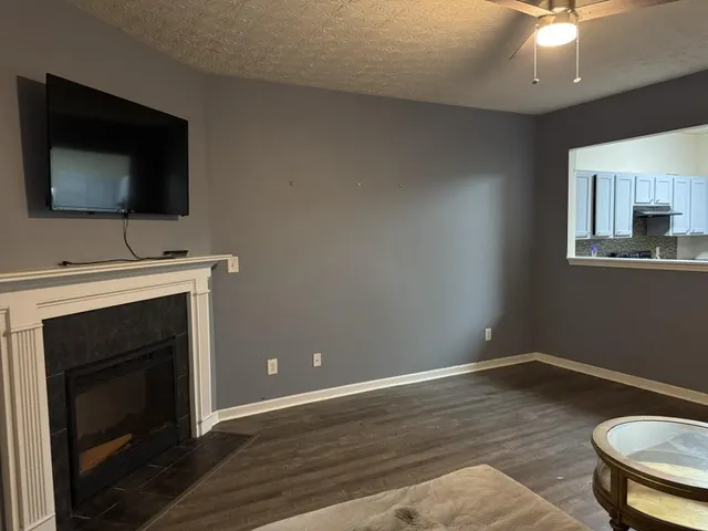 a living room with a flat screen tv and a fireplace