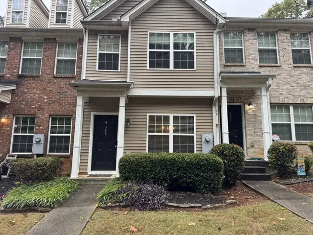 a view of a house with a small yard and plants