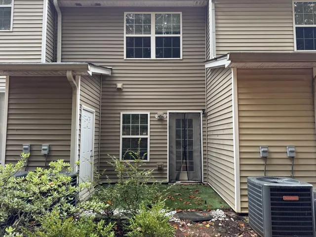 a view of a house with a yard and a garage