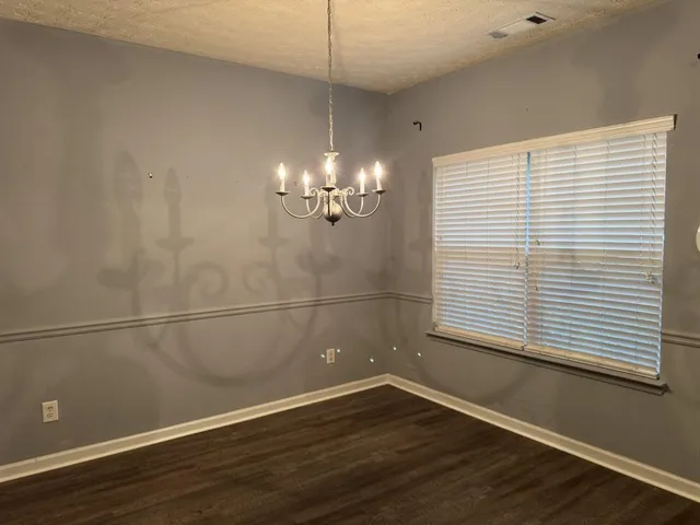 a view of a room with wooden floor and a window