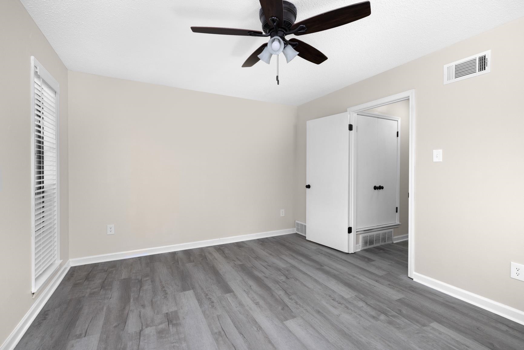 368 Tara Ridge Cove Collierville, TN 38017 - Photo 13 of 25 an empty room with wooden floor and windows