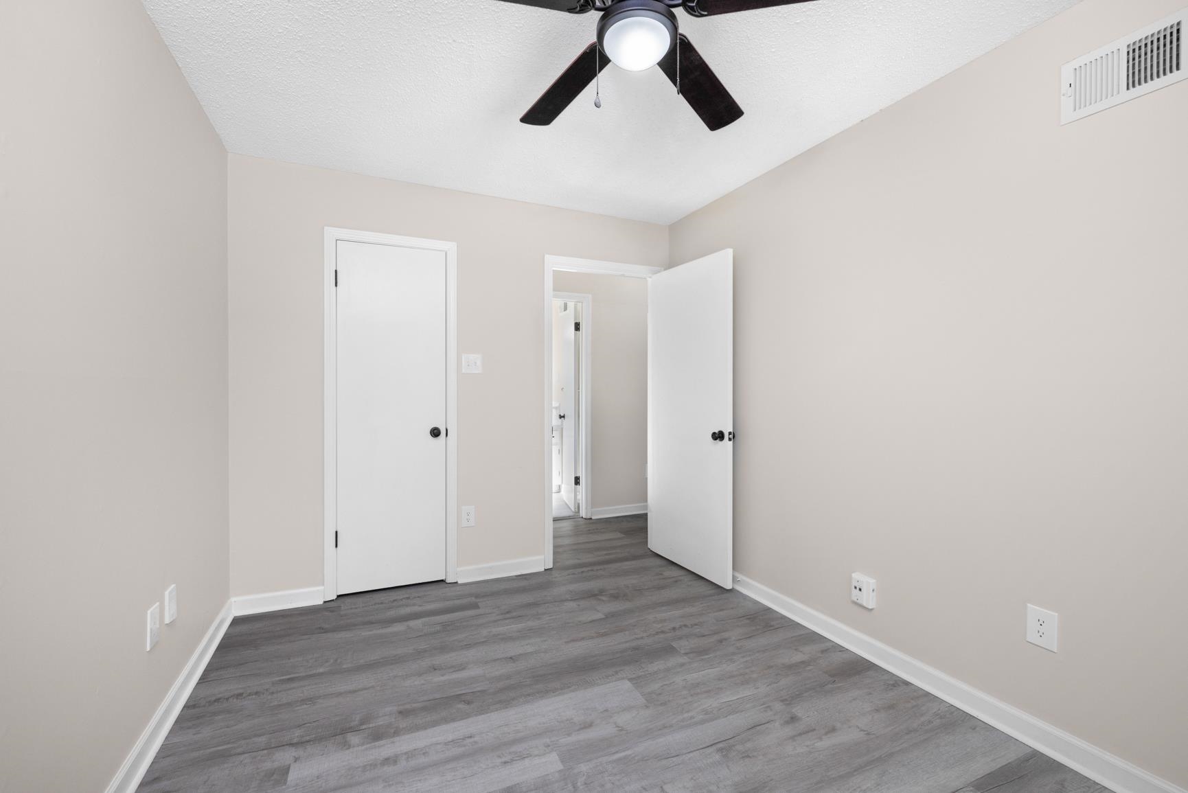 368 Tara Ridge Cove Collierville, TN 38017 - Photo 16 of 25 an empty room with wooden floor and windows