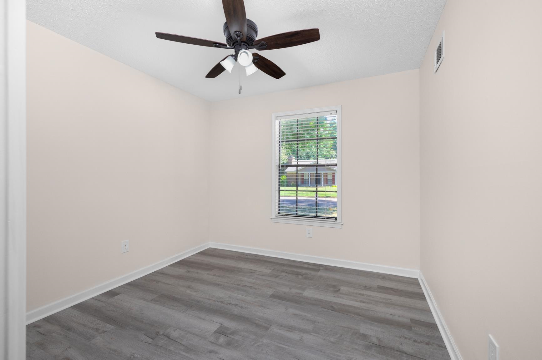 368 Tara Ridge Cove Collierville, TN 38017 - Photo 18 of 25 an empty room with wooden floor ceiling fan and window