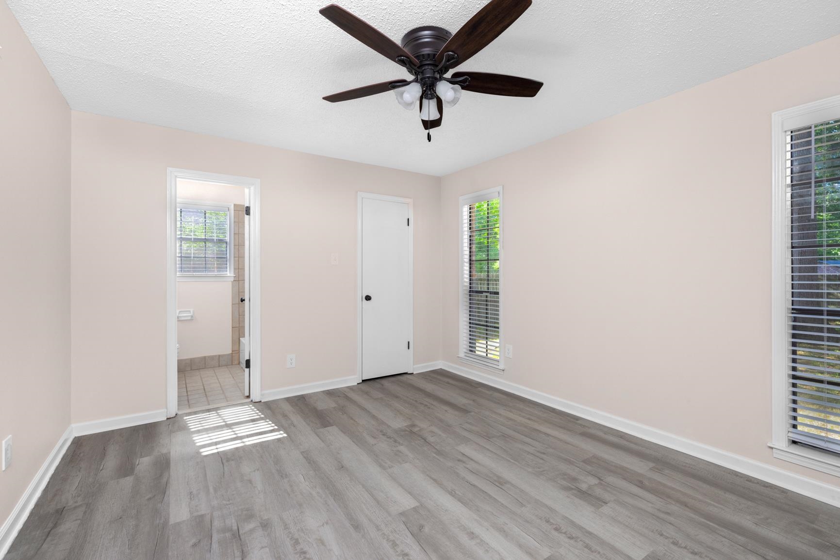 368 Tara Ridge Cove Collierville, TN 38017 - Photo 10 of 25 an empty room with wooden floor and a ceiling fan